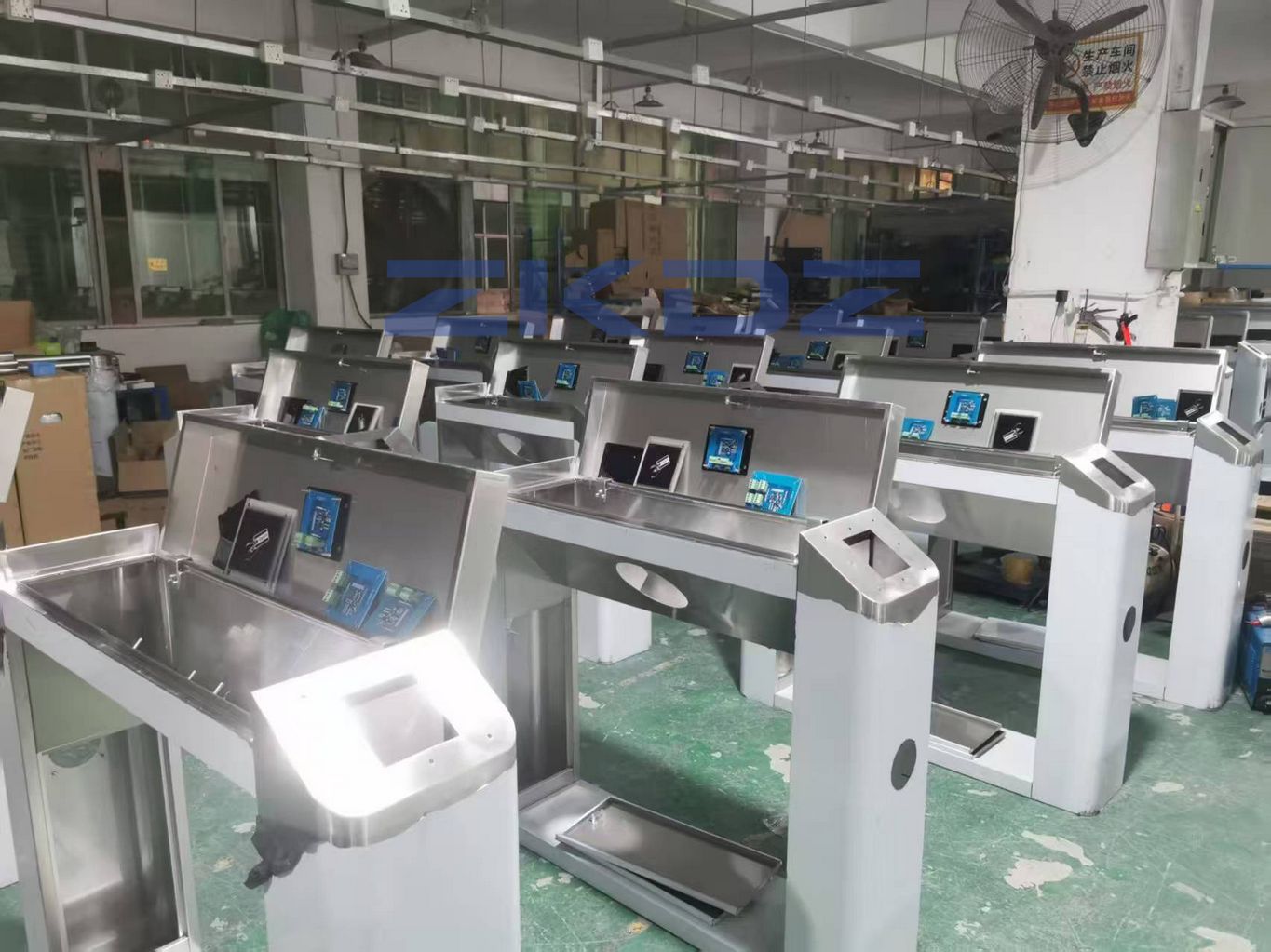 Installation of automatic drop arm turnstile gate at industrial warehouse factory